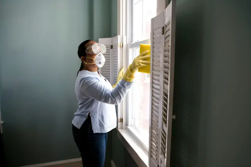 Painter preparing a window frame